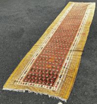 An old Northwest Persian Kilim runner, with a central panel of small geometric botehs, 482cm x 101cm
