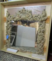 A large and impressive later 18th /early 19th century continental wall mirror, framed in carved