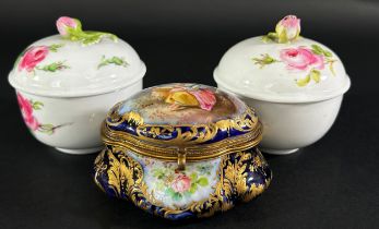 Two Meissen pots and covers with rose finials together with a small Sevres blue and gilt lidded