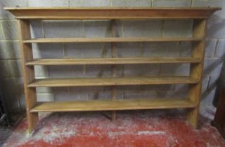 A stripped pine kitchen open plate rack with four fixed shelves and chamfered detail, 133 cm high