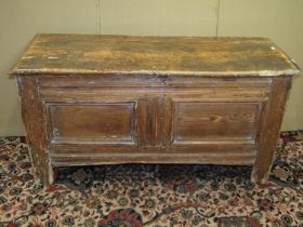 An 18th century pine coffer with hinged lid and panelled frame