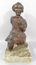 An 18th century carved oak figure of a man in a tunic and pantaloons clutching a cross to his