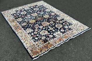 A Serapi type carpet with a large floral design on a blue ground, 220cm x 160cm.