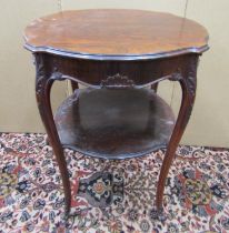 A Victorian rosewood centre table, the circular shaped outline raised on four shaped supports with