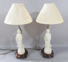 A pair of figural table lamps, with Chinese Blanc de Chine figures of Guanyin, 40cm tall.