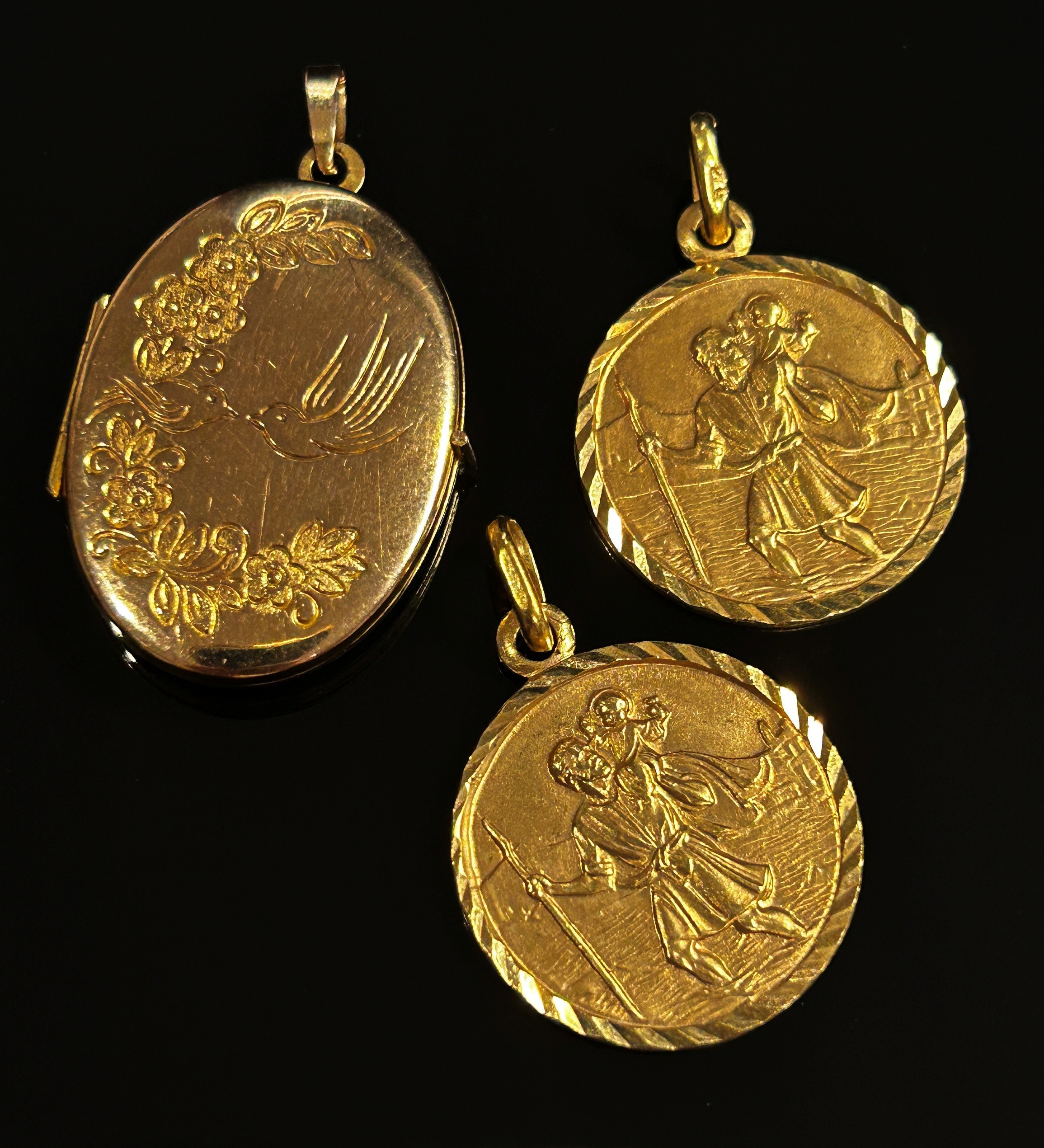 Three 9ct pendants; two St Christopher examples and a locket with engraved decoration, 9.4g total ( - Image 2 of 5