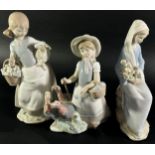 Three Lladro figures, one of a girl shepherding Turkey's, another holding a Lamb, a third with a