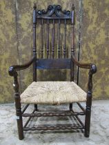 An 18th century or possibly earlier open elbow chair, the stained walnut and beechwood frame with