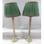 A pair of brass column lamps both with shades, 60cm high approx.