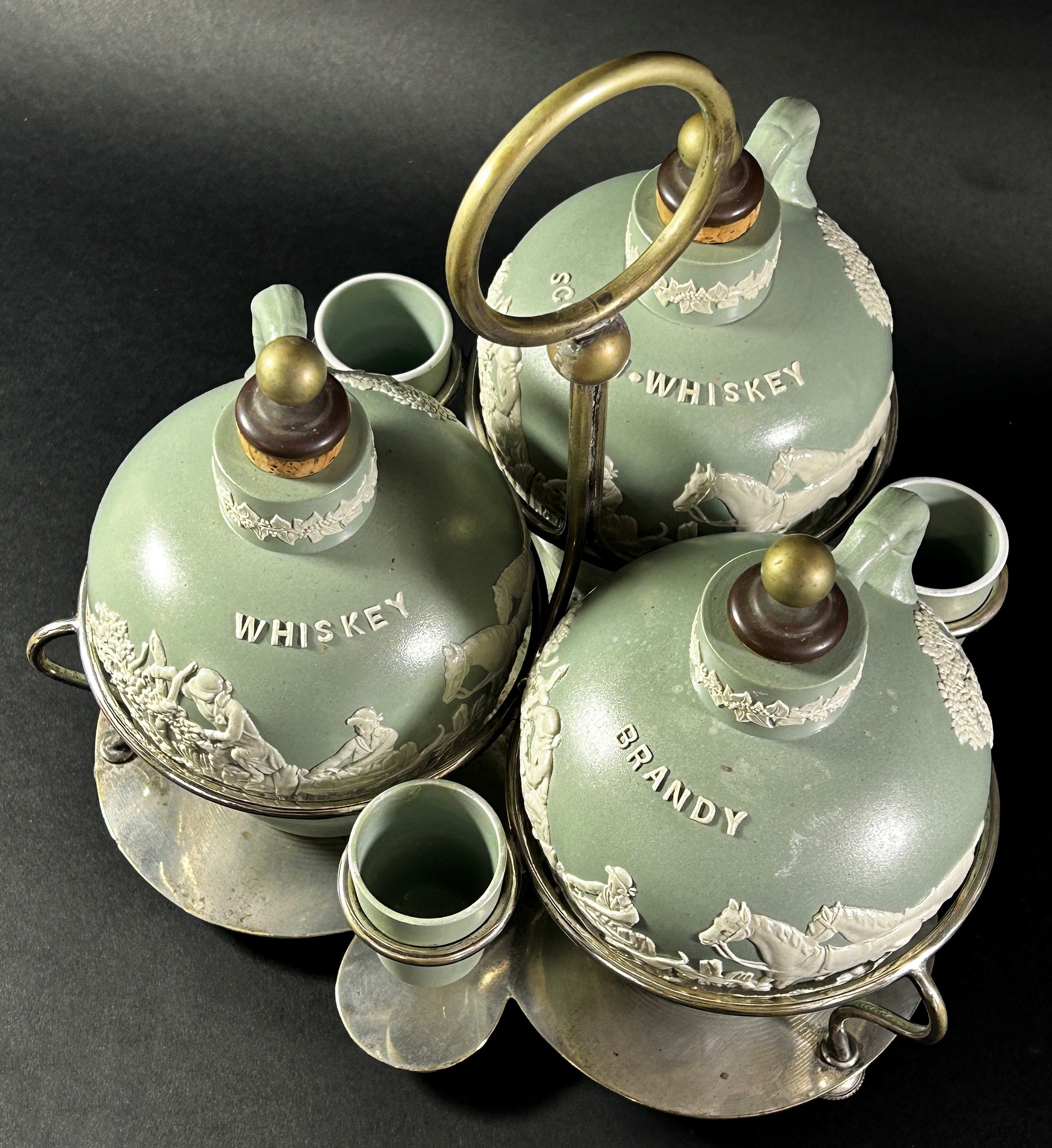 A late 19th century three bottle tantalus ceramics and silver plate frame, supporting three - Image 2 of 3