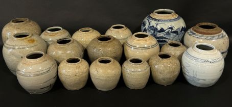 A collection of provincial Chinese blue and white and other stoneware ginger jars, some with