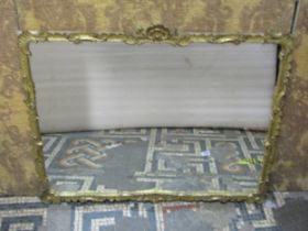 A decorative gilt framed mirror with scrolled detail, 60cm high x 73cm wide