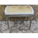 A 19th century footstool in a distressed chalk green painted finish on reeded tapered supports