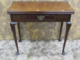 A Georgian mahogany rectangular fold over top tea table with central frieze drawer raised on