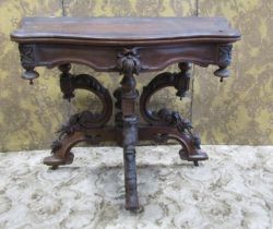 A unusual Victorian walnut fold over top tea table with serpentine moulded outline and trailing