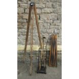 A vintage cast iron and brass four divisional umbrella/stick stand containing various canes and