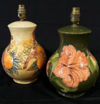 Two Moorcroft table lamps - Hibiscus pattern and Finches on an open ground, 25cm high (not including