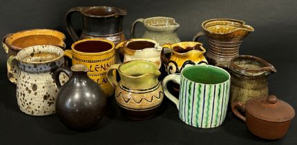 A collection of studio pottery ware to include mug and jugs by Ronald Jones of Winchcombe Pottery