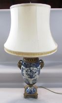 A 19th century style blue and white crackle glazed lamp with gold satyre masks with a shade, 57cm