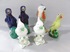 A pair of Chinese export ceramic parrots, a pair of porcelain cockatoos, a yellow parrot and a