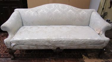 A large 18th century style country house sofa with camel back and scrolled arms, raised on carved