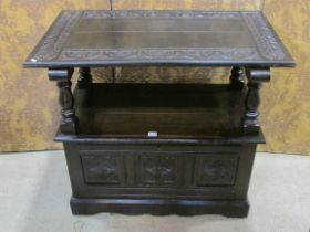 A carved oak monks' bench with hinged box seat, 78 cm high (closed) x 92 cm wide x 56 cm deep