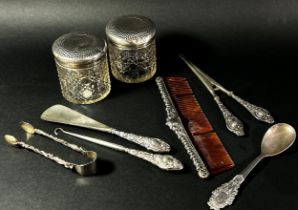 A matching set of three silver dressing accessories, a shoehorn glove stretcher, a button hook, a