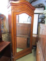 A 19th century mahogany wardrobe with arched outline, enclosed by a mirror panel door, 225cm high