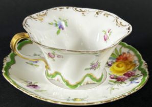 A Dresden cabinet cup and saucer with hand painted floral sprays within green and gilt bands