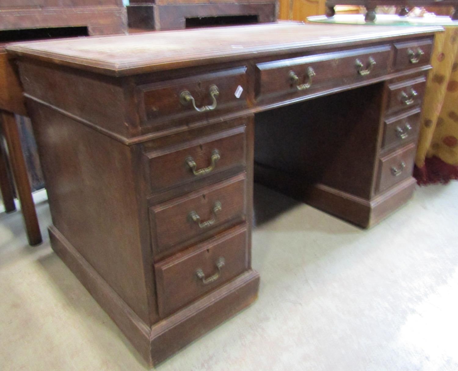 A Victorian oak kneehole twin pedestal desk with inset leather top over an arrangement of nine - Image 2 of 3