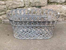A vintage cast iron oval planter in the form of a lattice work basket, 25 cm high x 54 x 28 cm