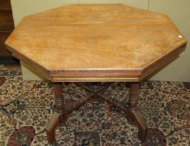 A Victorian mahogany centre table of octagonal form, raised on four carved supports united by an X