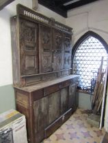 A substantial antique Breton two sectional side cupboard, the upper enclosed by a pair of sliding