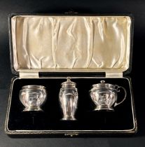 A cased set of Art Deco silver condiments, Birmingham 1921, maker Adie Brothers Ltd, all with