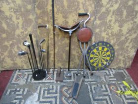 A shooting stick, golf club, riding crop, golf club stand, dart board, snooker cloth iron