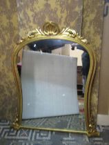 A Victorian overmantle mirror, with shaped outline beneath a shell and acanthus scroll with gilded