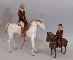 Two 19th century horse and rider leather toys comprising a white horse height 20cm with rider