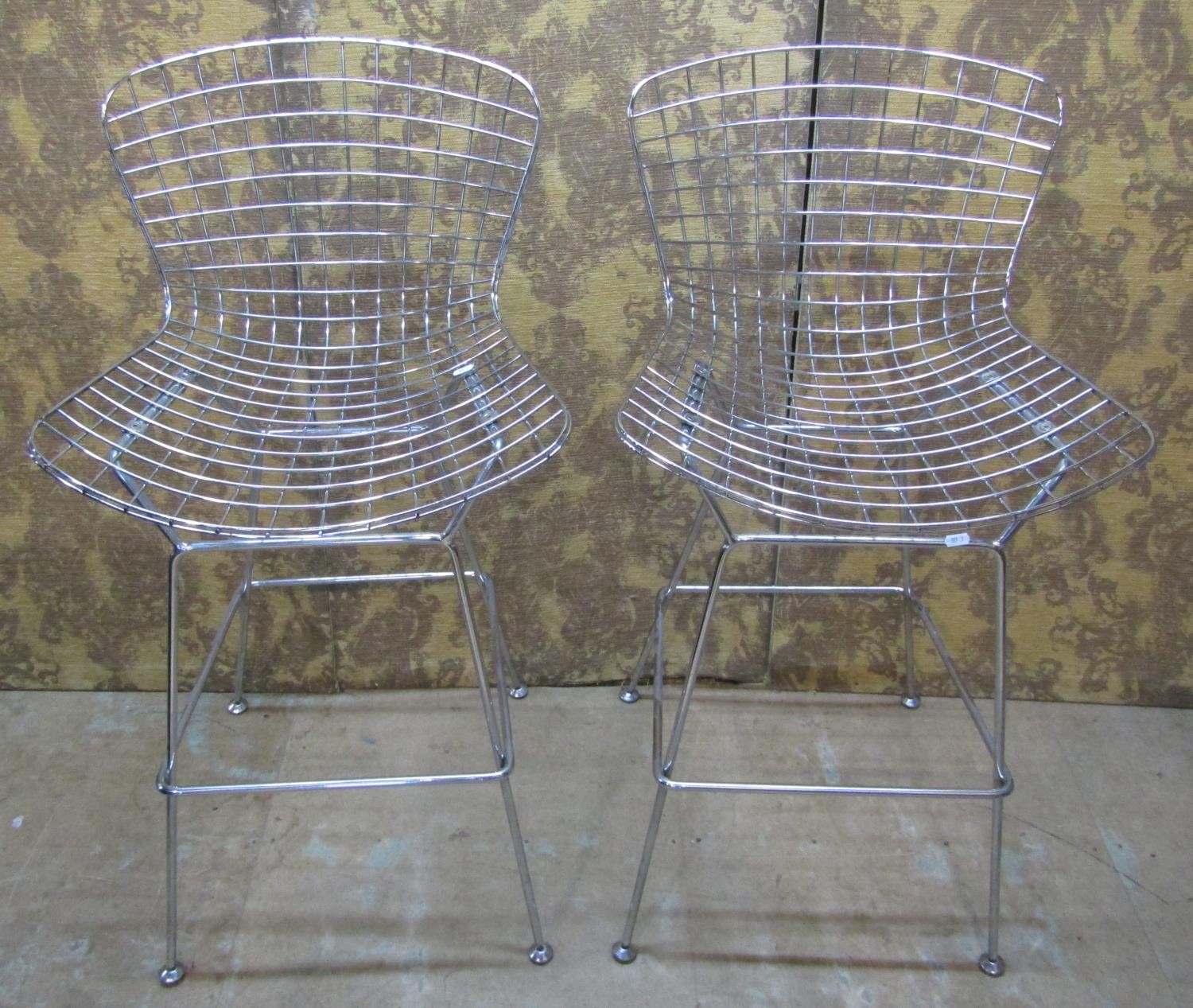 A pair of contemporary chrome Burtola style wire highchairs on splay supports