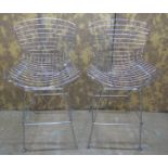 A pair of contemporary chrome Burtola style wire highchairs on splay supports