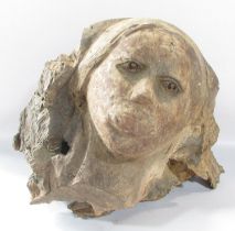 A Sculptured Human Head, carved from a natural piece of wood, 35cm high x 50cm wide.