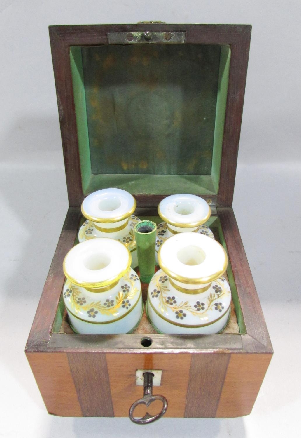 A 19th century continental scent bottle box with a ring handle opening to reveal four opaque scent