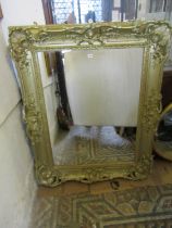 A large 19th century swept and moulded gilt gesso framed wall mirror with scrolling acanthus,