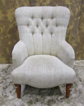 A contemporary button back chair on turned supports