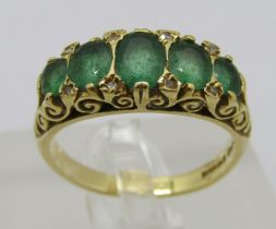 Antique style 18ct graduated emerald and diamond ring, Sheffield 1994, size M/N, 5.2g