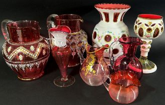 A varied collection of Bohemian and Cranberry glassware, including a Bohemian glass overlay vase and