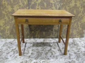 An Arts & Crafts oak side table with shallow frieze drawer raised on square cut and moulded