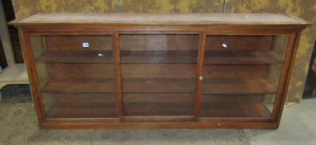 A pitch pine framed side cabinet enclosed by a pair of rectangular glazed panelled doors, 72 cm high