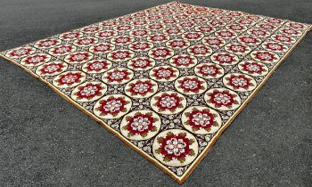 A 19th century needle point carpet/wall hanging, with eighty circular panels with floral posies to
