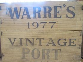 An opened wooden case of ten bottles of Warre’s 1977 Vintage Port.