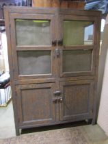 A 19th century partially stripped farmhouse food cupboard partially enclosed by panelled timber